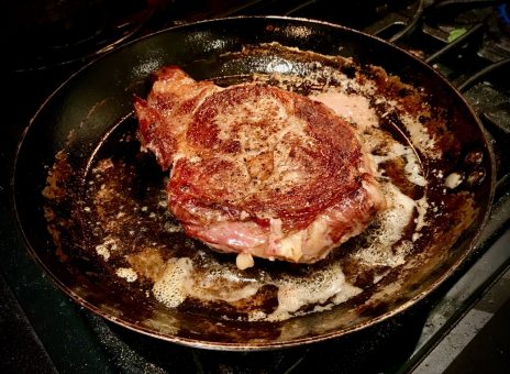 Ribeye steak in frying pan